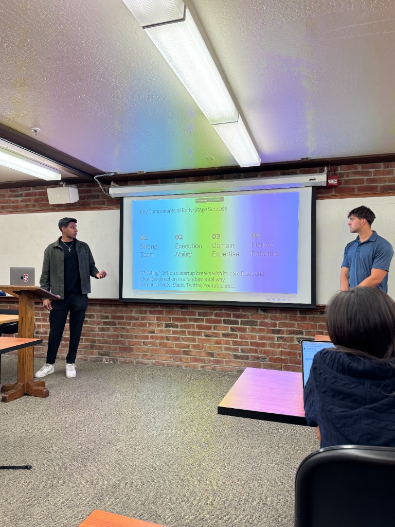 Two NGF facilitators taking questions from students during a workshop